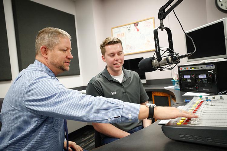 Student speaking into microphone